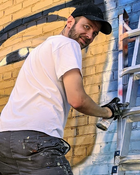 Adam Clark painting the Kendrick Castillo memorial mural, 2020