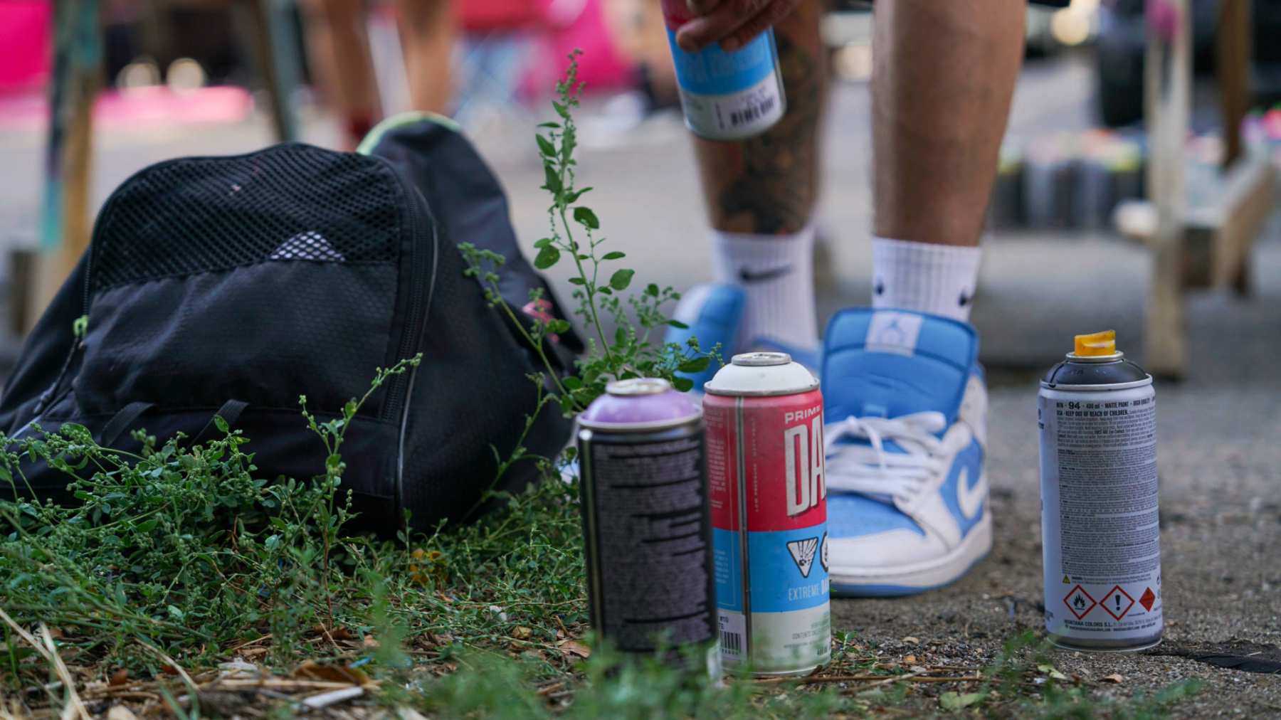 Spray cans on the ground at a graffiti jam. Photo by Cesareo Sifuentes